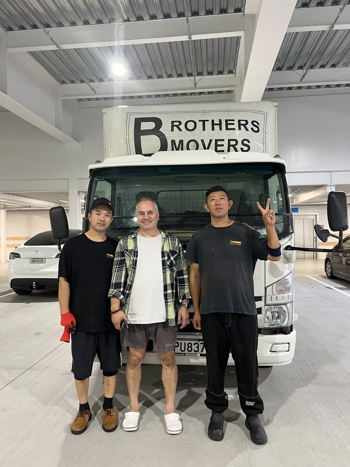 The Brothers Movers crew with their trucks